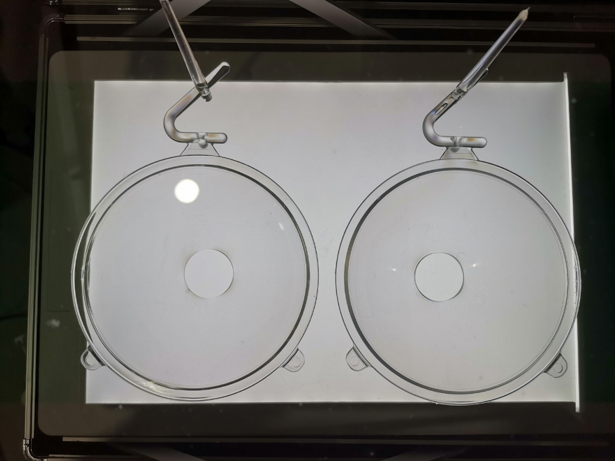 The products made by the practical molding experiment using polariscope to determine the optical characteristic is shown in Fig. 7. The fringed pattern only occurred in the runner and gate, suggesting a good optical quality of the Fresnel lens. The practical molding experiment verified the feasibility of Moldex3D results.